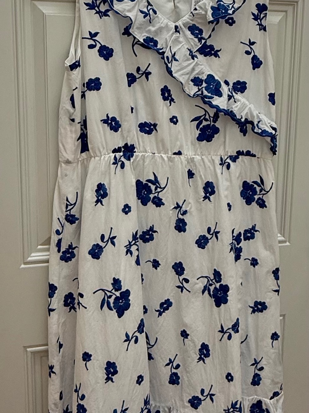 Sleeveless White Midi Dress with Blue Floral Print and Ruffle Trim